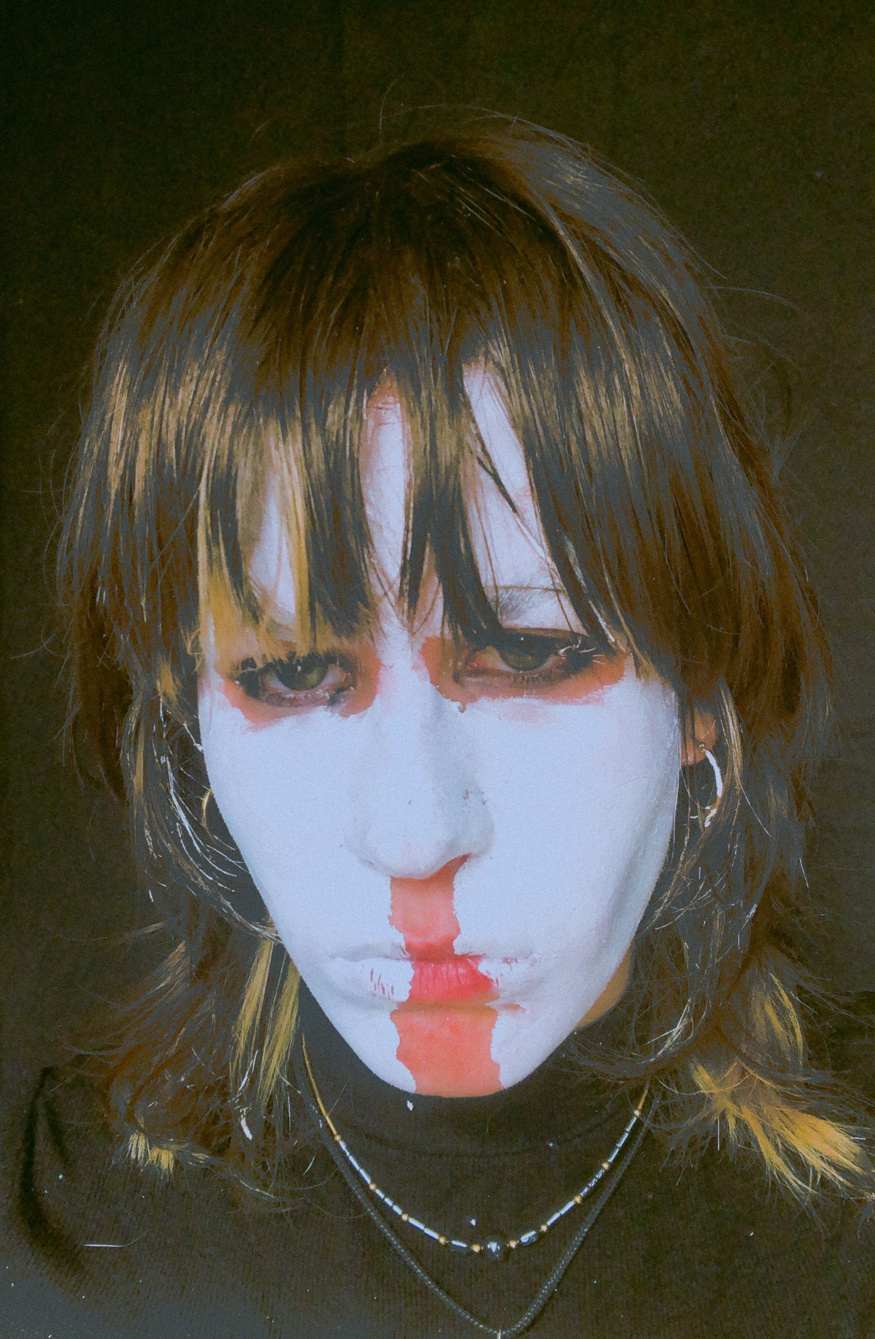 headshot of ed barth on black background wearing white facepaint