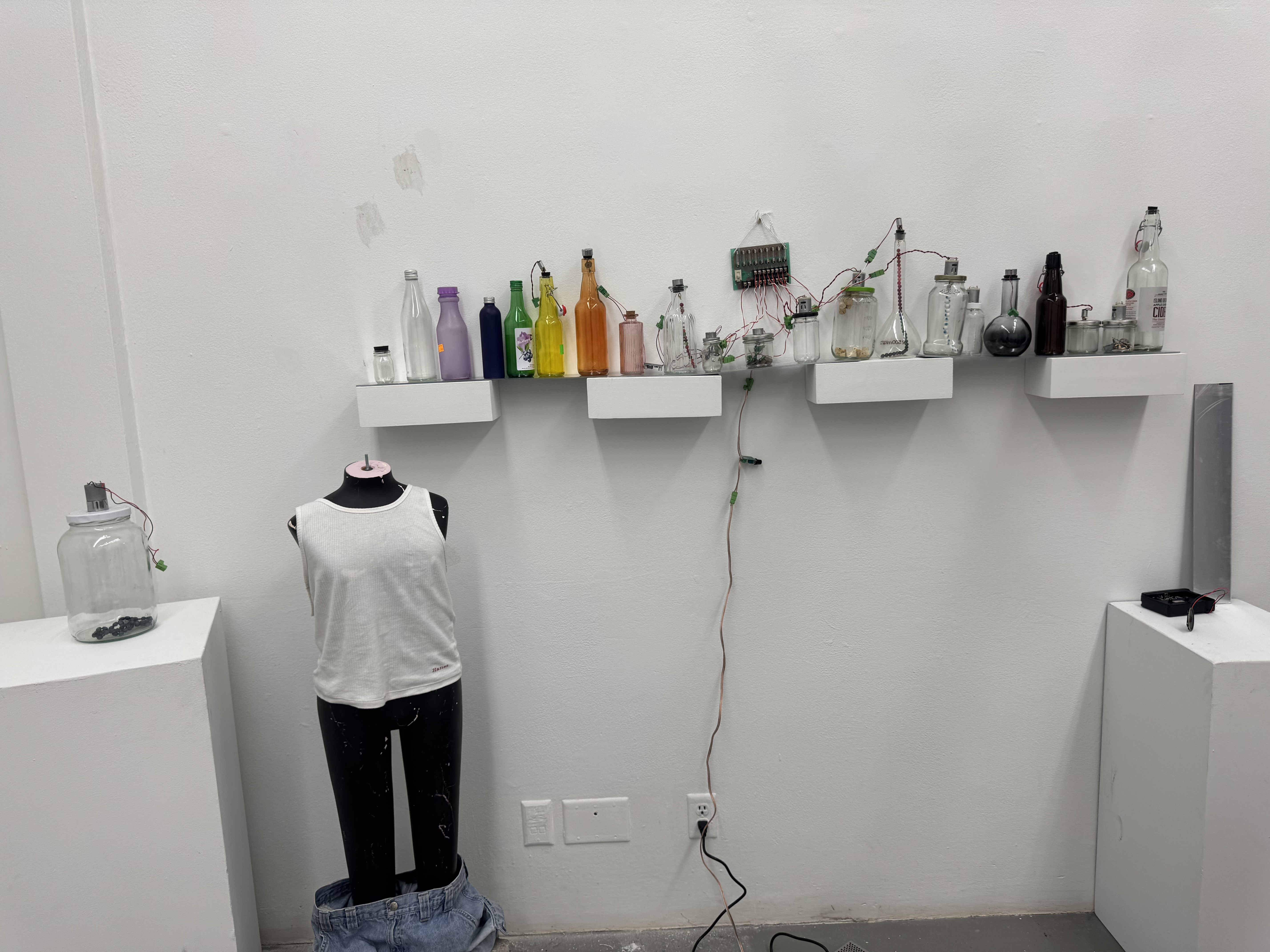 image of colorful jars on shelf and mannequin