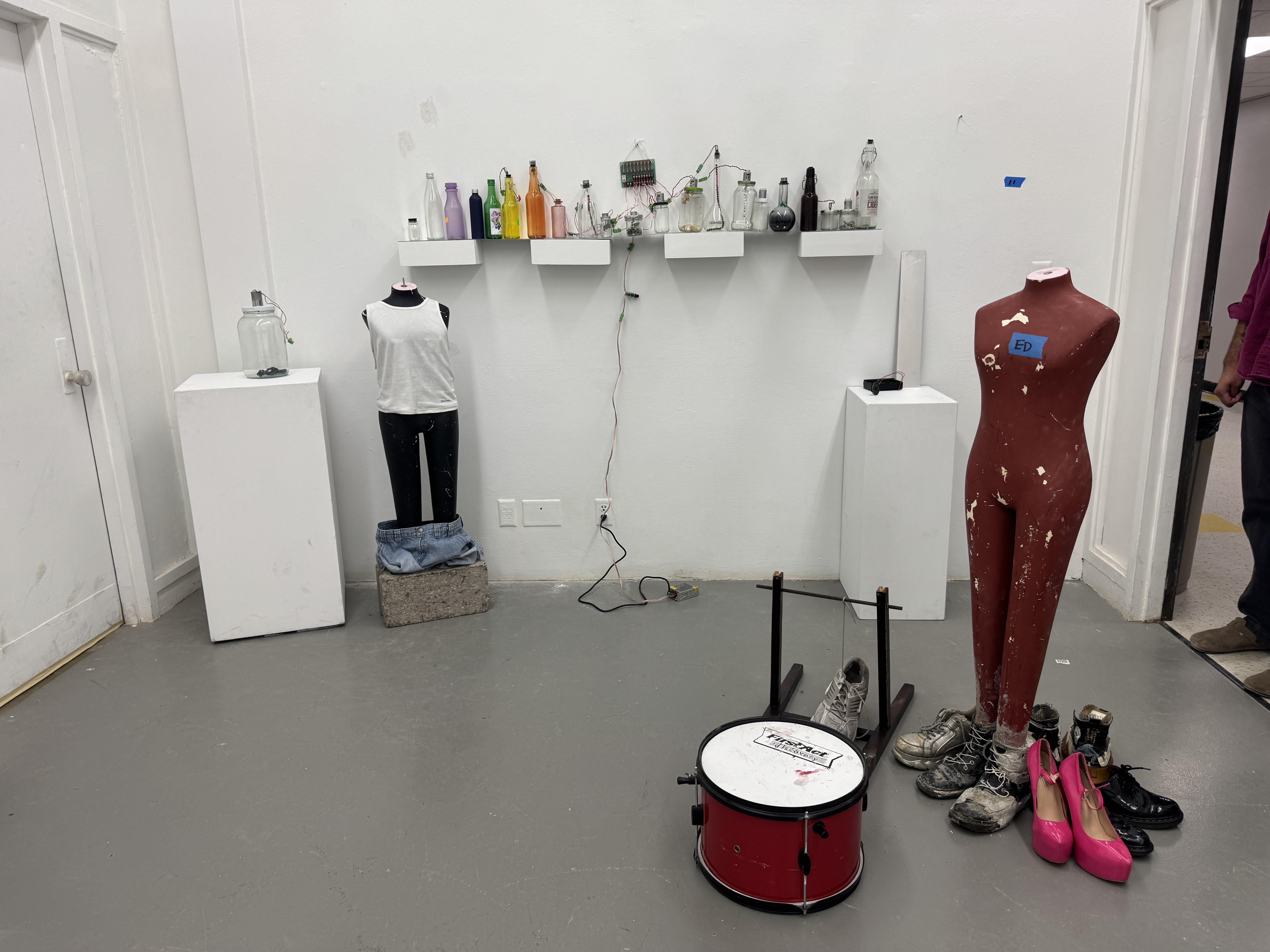 image of colorful jars on shelf and mannequin