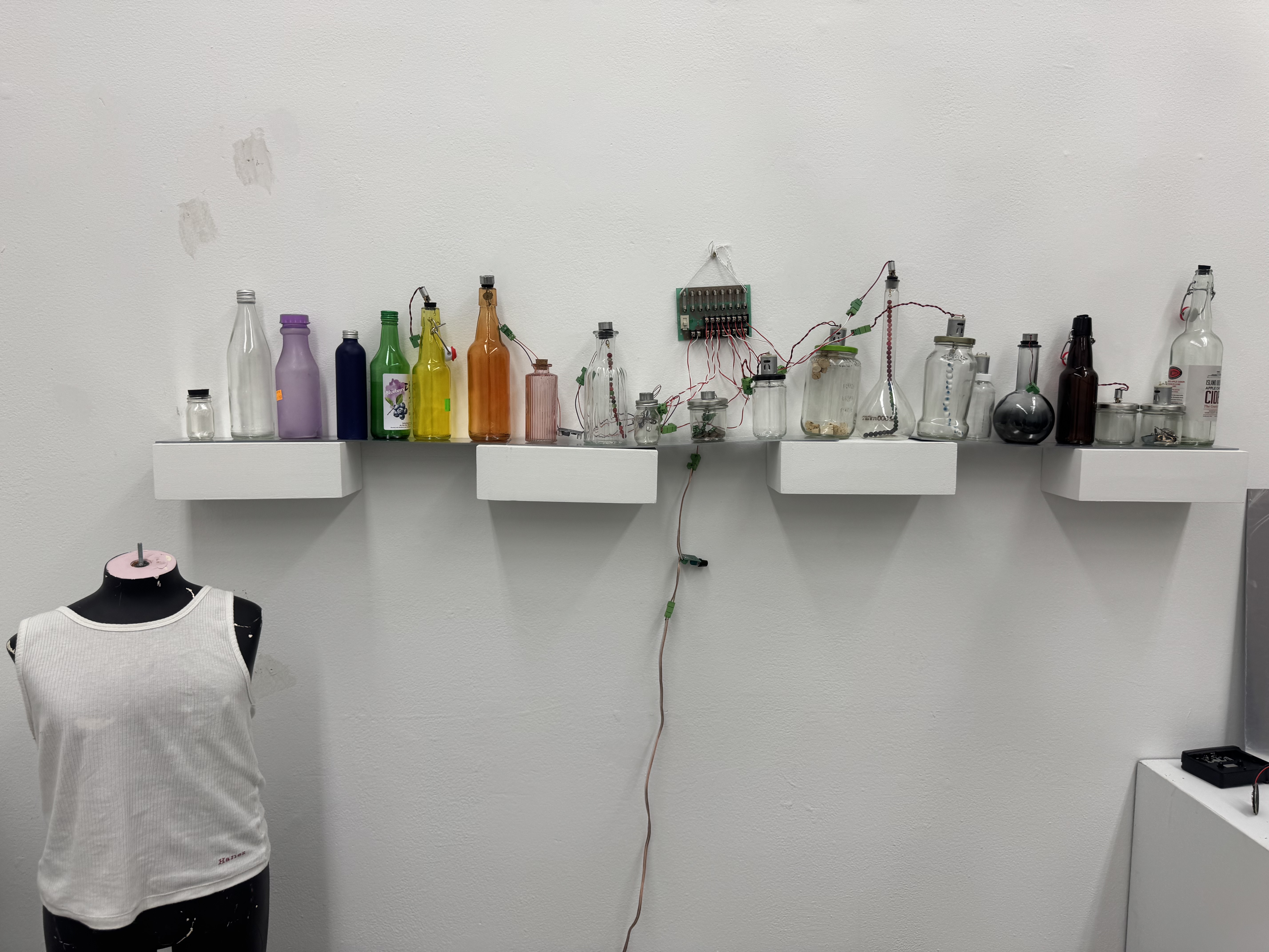 image of colorful jars on shelf and mannequin